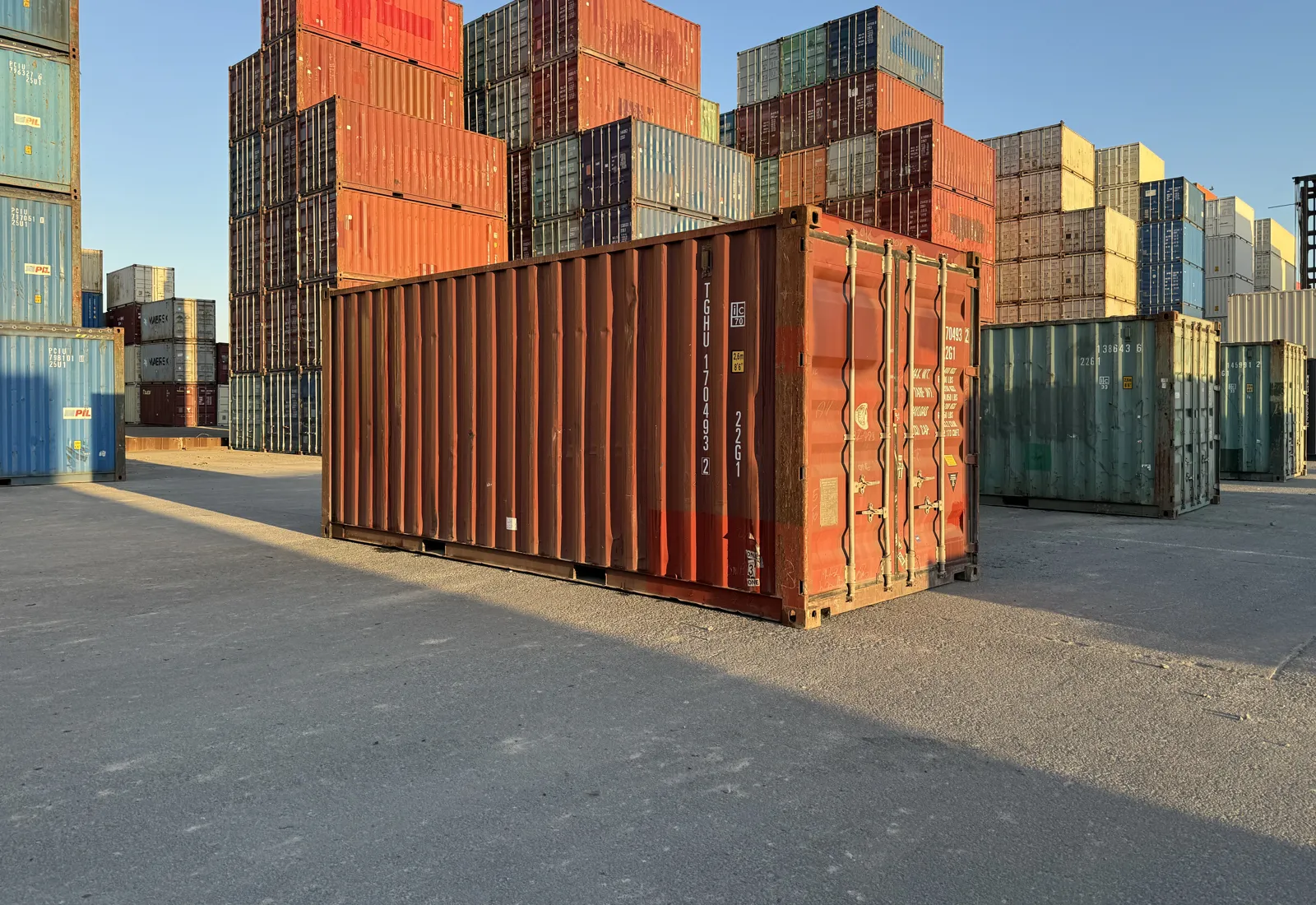Shipping container stock in the yard at golden hour